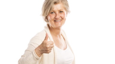 graphicstock portrait of a happy senior womanwith thumbs up isolated on white background BRlwS2O3b